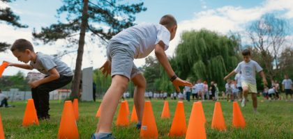Group of kids enjoying exercise and play at a park obstacle course.